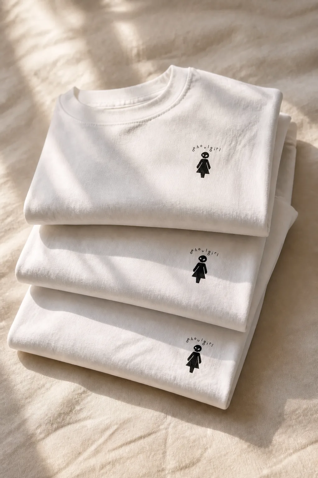 Editorial stack of white ghoulgirl t-shirts